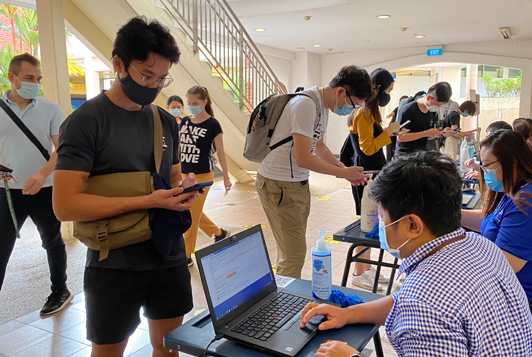 Top: Aegan Tan, a UTR resident, was the first in line at the registration counter. <br/>
Bottom: Aegan getting ready for his swab test by HPB officers. 