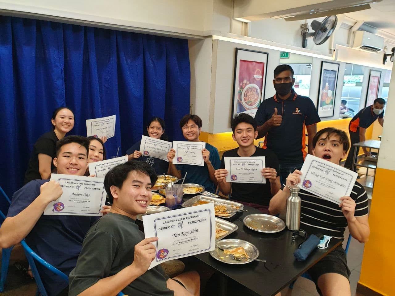 NUS Faculty of Law students enjoying their prata meal after completing the workshop. 

