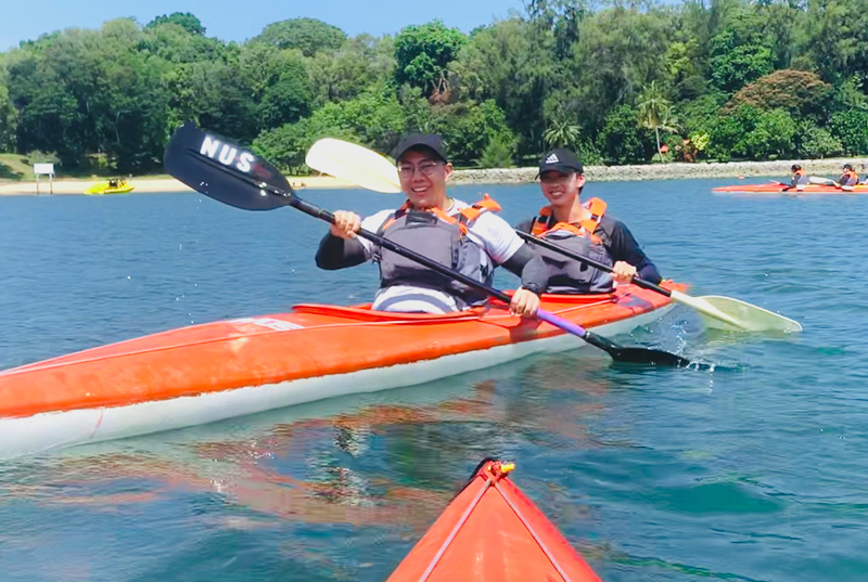 Off the Coast: Students spotting huge grins as they paddle on their kayaks
