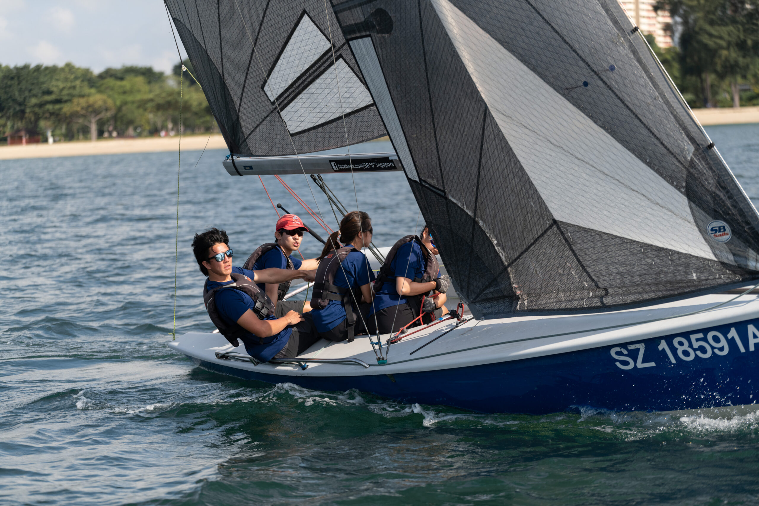 Trimming the sails with precision to make the boat go as fast as possible – “You can't change the wind but you can adjust your sails”, says Matthew Scott Lau (pictured second from left) 

