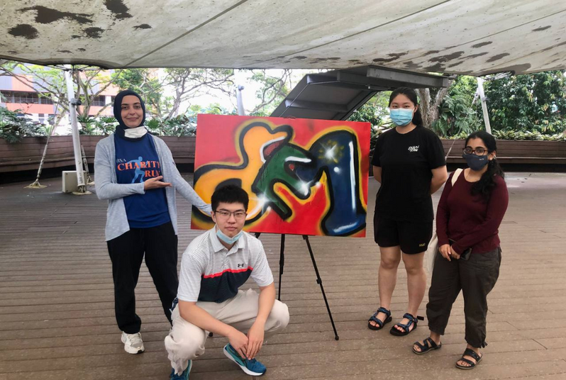 A group all smiles as they posed for their shot with a finished look on their artwork

