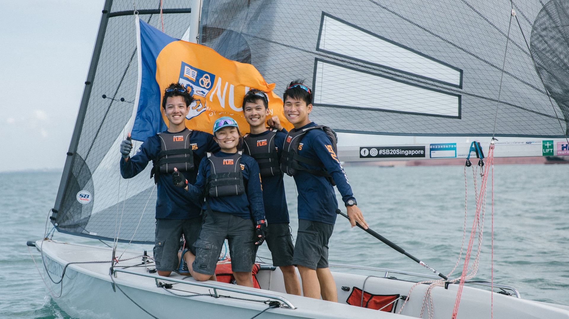 The NUS Sailing team comprising crew members Matthew Scott Lau, Andria Tan, and Keith Yeo, and helmsman Riji Wong sailed into the first position at the Asia Pacific Championship 2021. (Photo: NUS Varsity Sailing Team)