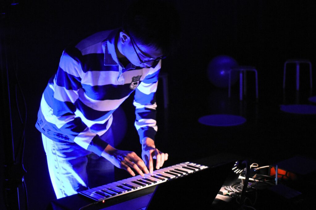 Yim Qi Yao, Co-Head of Publicity of NUS Electronic Music Lab is one of four student musicians who worked with Syafiq Halid on this production. He goes by the stage moniker thre3Bs.