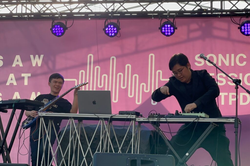 Le Tu Quoc Dat (Year 1, Computer Science, left) performs on the guitar alongside  alumnus Tan E-Reng (right) on the synthesisers.