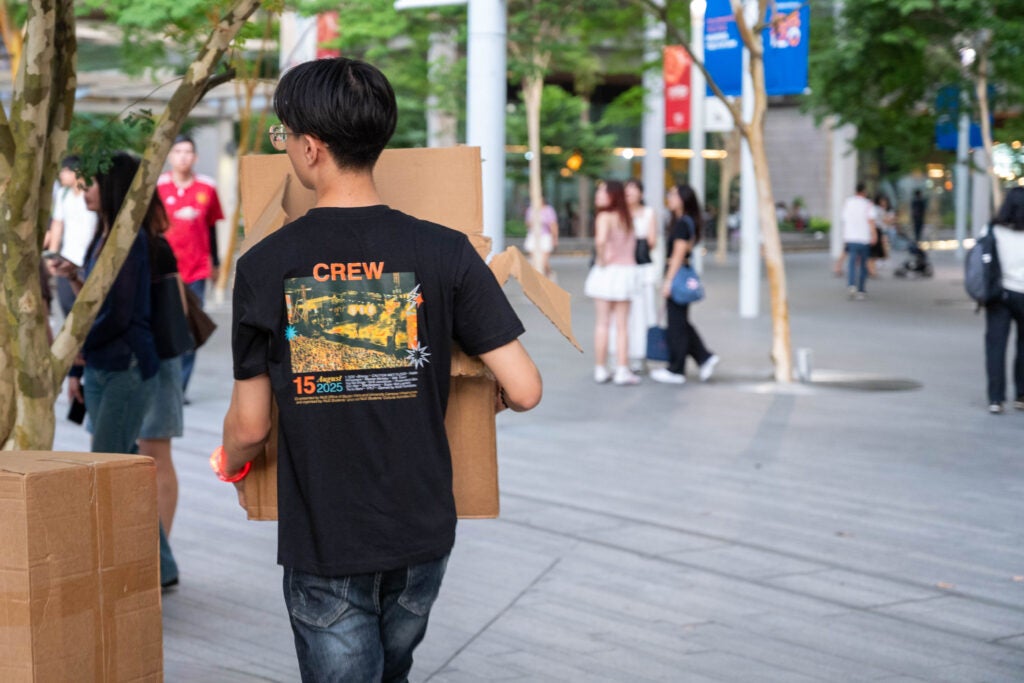 Behind the scenes: SUPERNOVA student volunteers carry boxes of sponsored goodies, powering the carnival so that their peers can enjoy the show. 