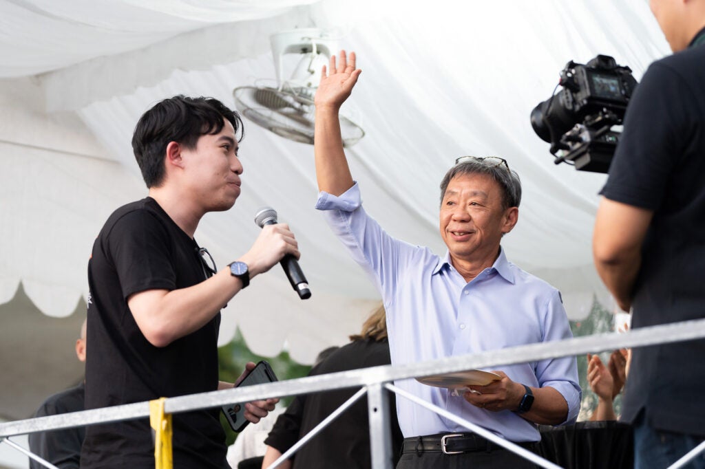 Legacy in the making: NUSSU President Sean Pang (left) with Professor Tan Tai Yong, former NUS Vice Provost (Student Life, 2010–2014), whose vision in 2013 sparked the idea of a Woodstock-style concert for NUS students. 