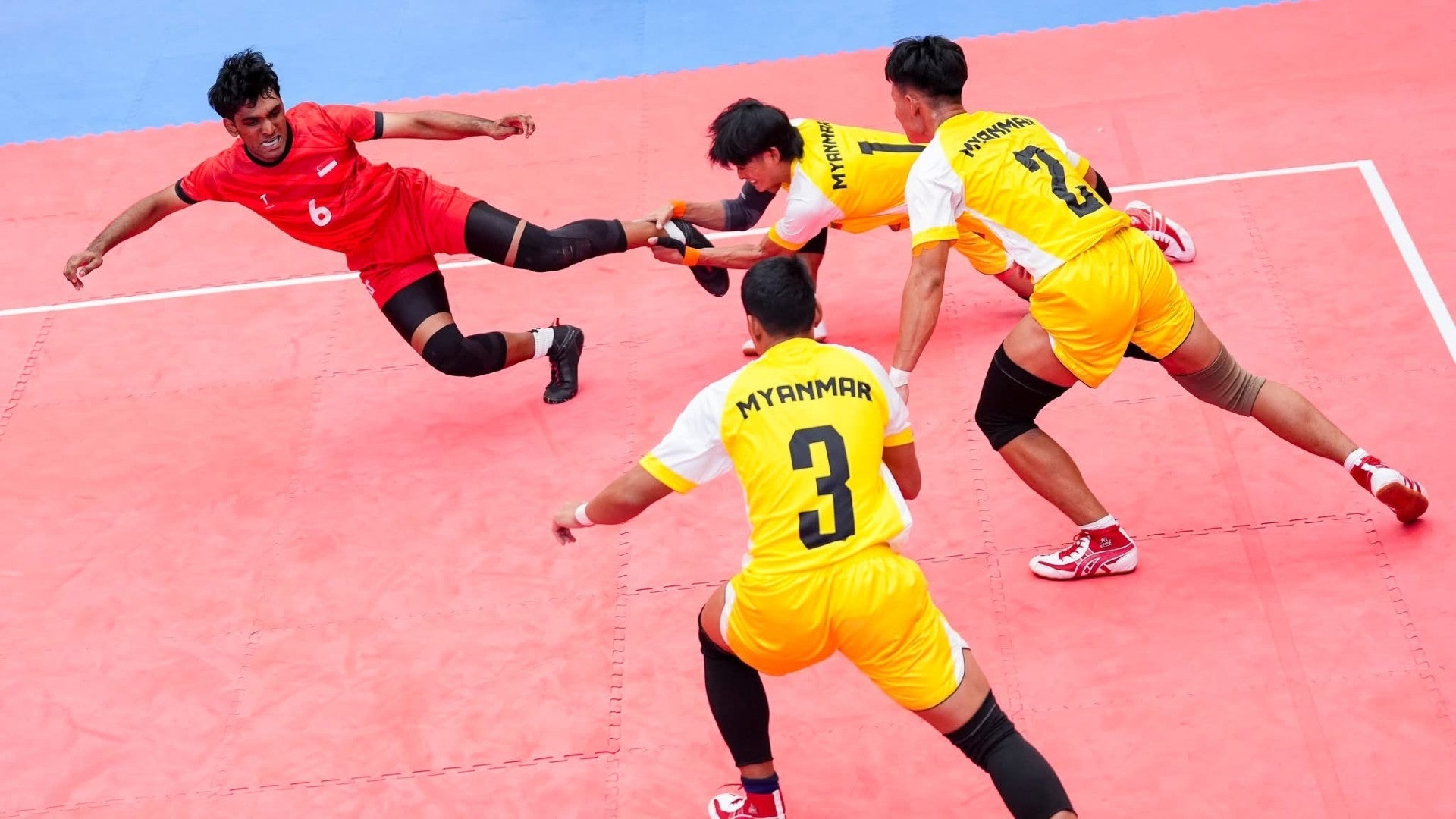 Fierce moves from first-year Computing undergraduate Raja Sri Raam (in red) during the Men’s Standard Style Kabaddi team’s journey to their SEA Games bronze. (Photo: Singapore National Olympic Council)