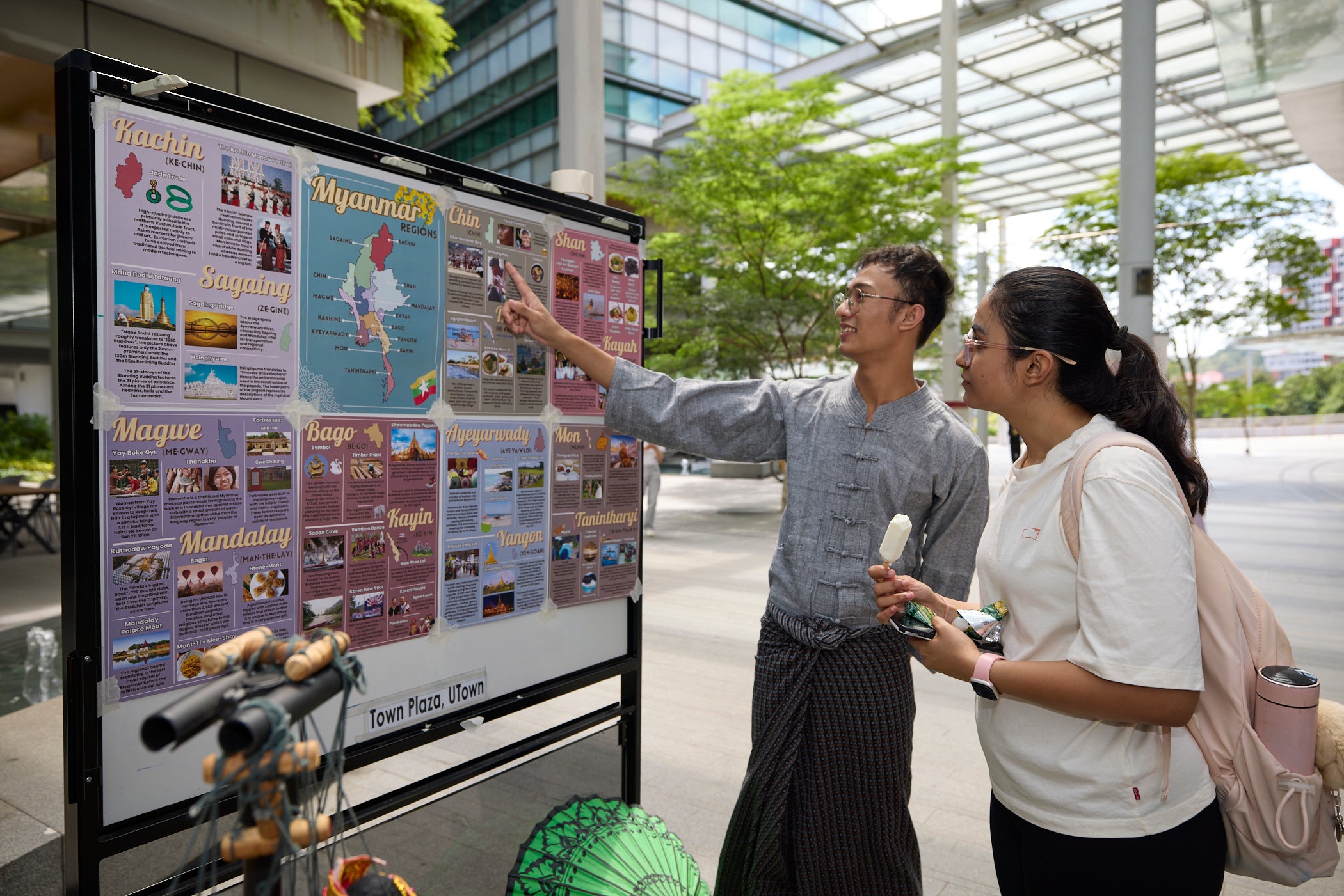 The Myanmar Community @ NUS showcasing the Burmese culture through traditional wear, language, and snacks.