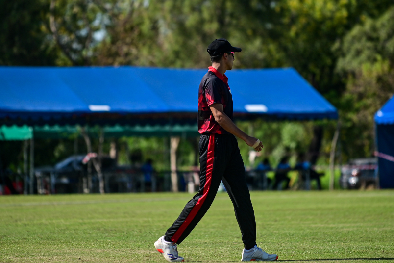 A quiet moment of strategy on the pitch as Raoul fields, focused on the ball.